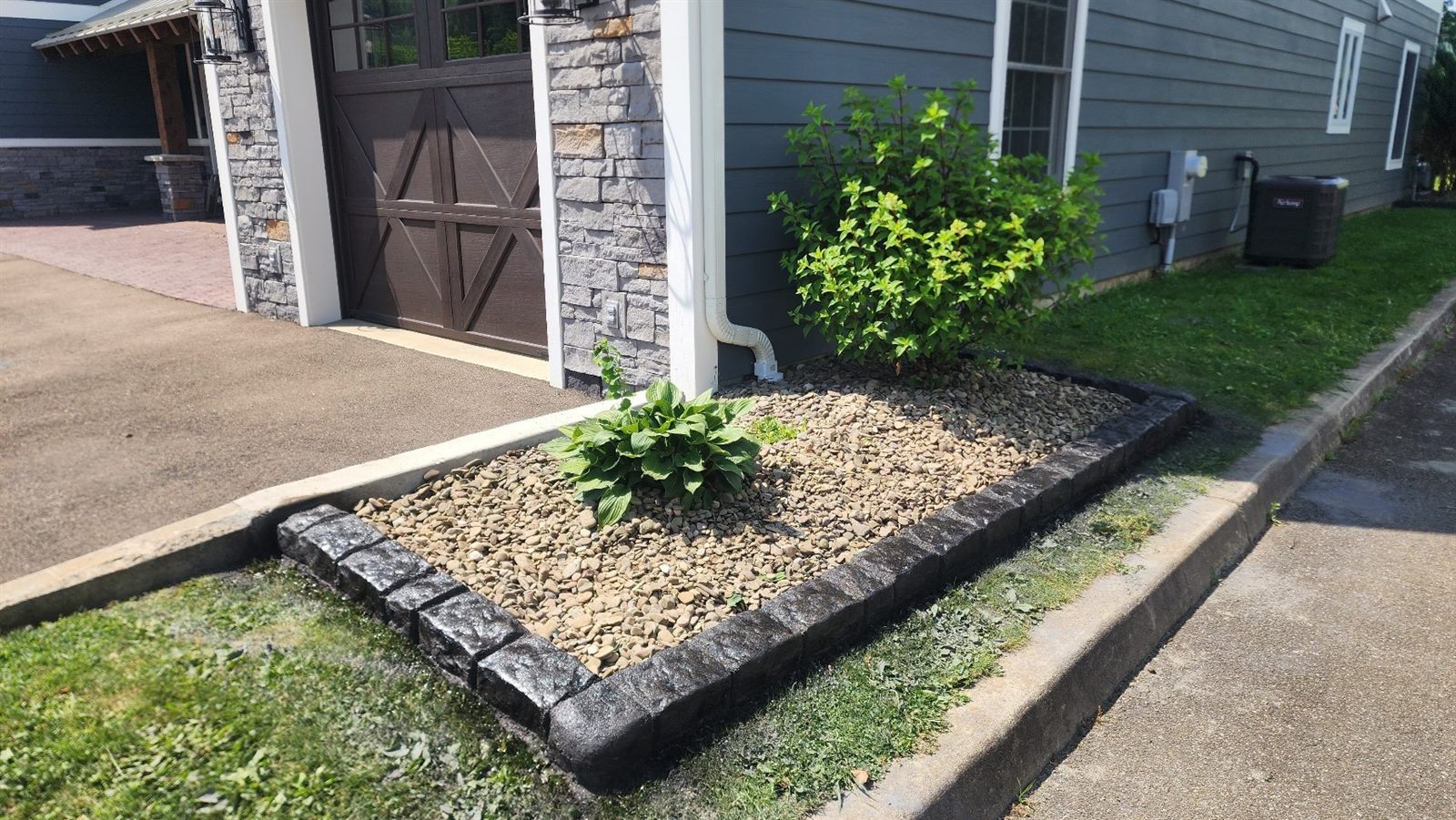 Decorative curbing along a driveway bed