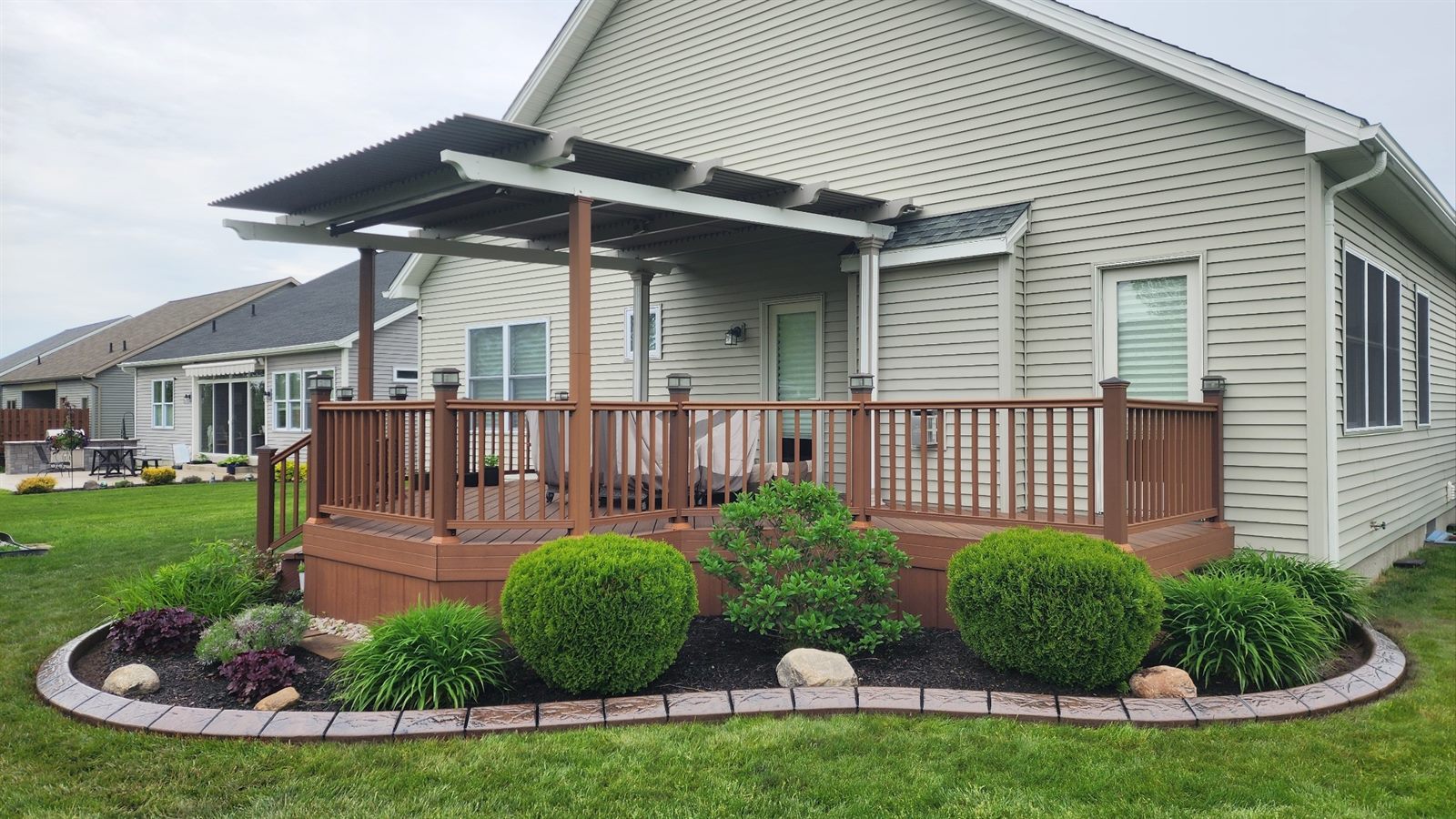 Decorative curbing around a backyard deck